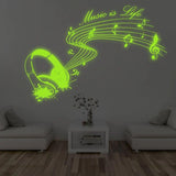 Наушники, ноты и текст Music Is Life на стене