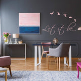Stylish living space featuring the 'Let it be...' vinyl wall sticker with birds and contemporary decor.