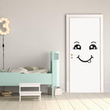 Smiley face wall decal on a white door in a cheerful children's bedroom with a blue bed.