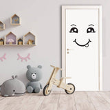 Smiley face decal on a door in a cozy room with toys, adding a cheerful touch to the decor.